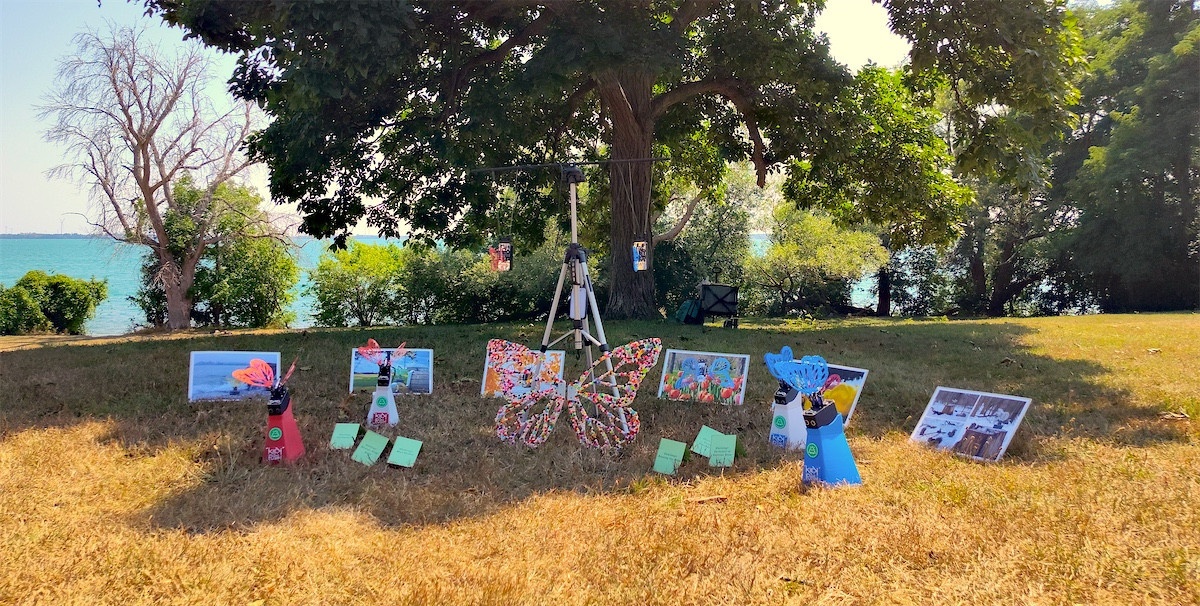 Robot in the Park setup with the Robot Butterflies on stands, photographs setup outdoors, and the quest cards