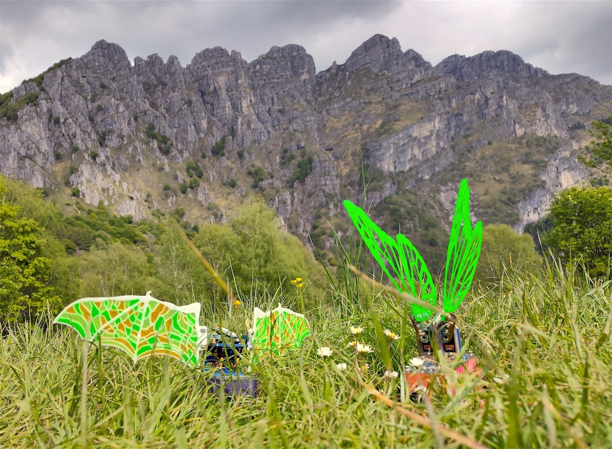 Robot Butterflies before a towering mountain
